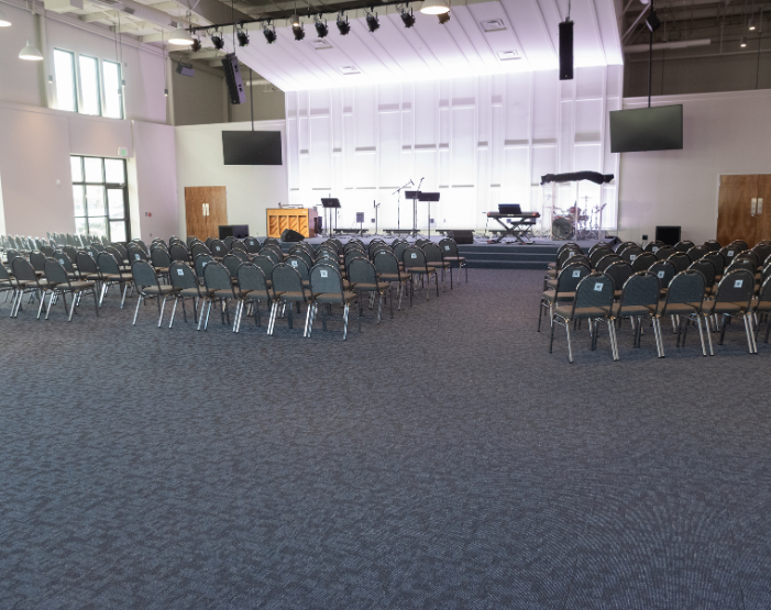 commercial flooring in musical room with chairs and stage and lights